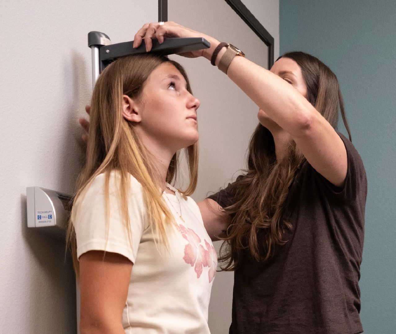 A girl is having her height measured
