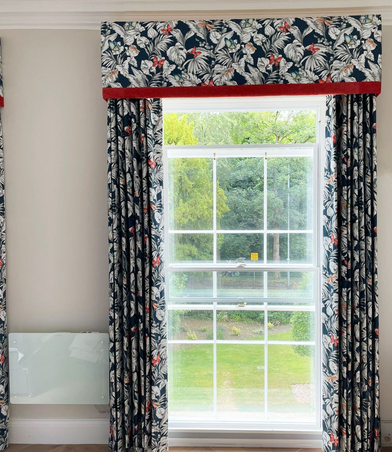 Single pleat blackout curtains with a pelmet trimmed in burnt orange fabric