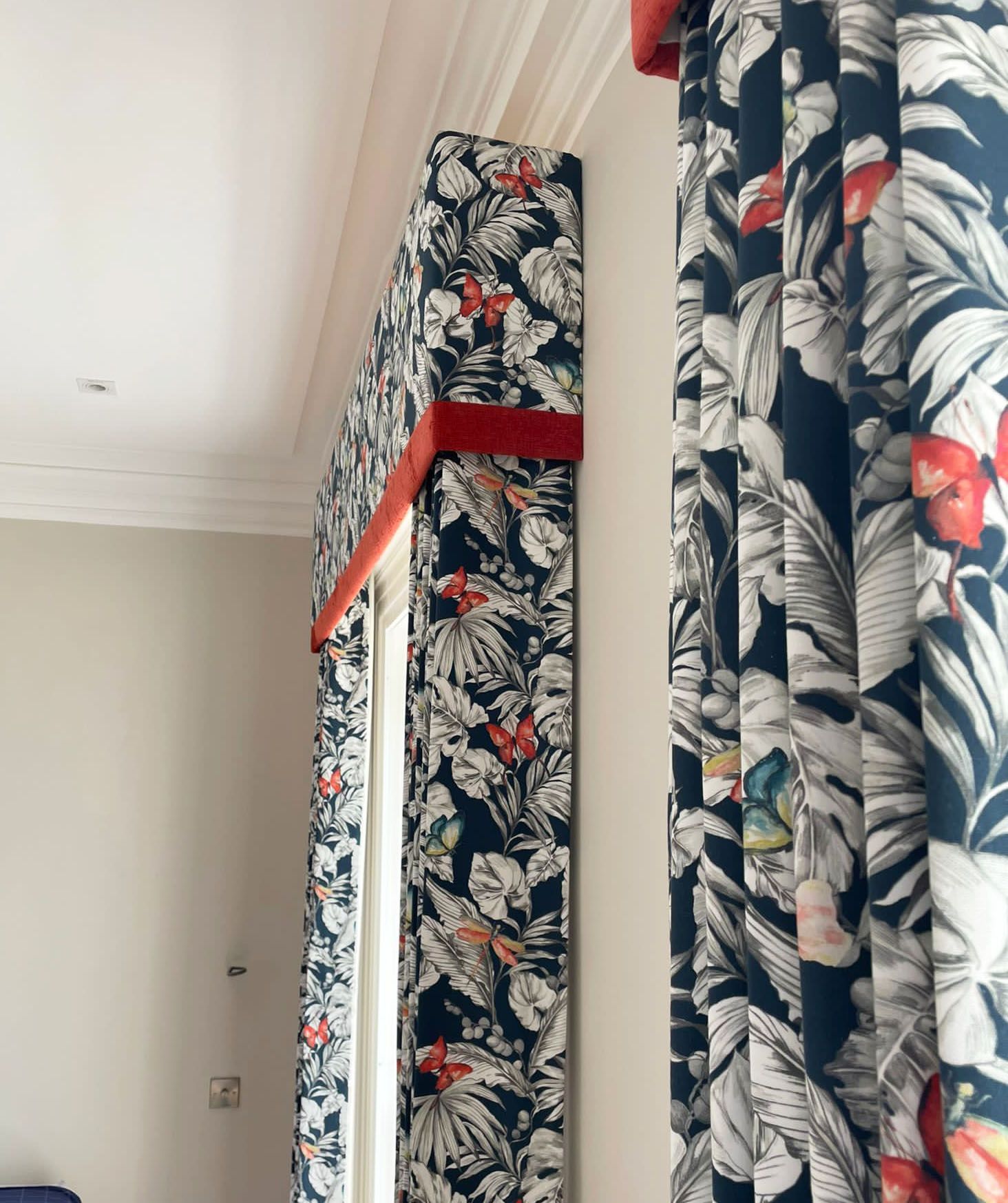 Single pleat blackout curtains with a pelmet trimmed in burnt orange fabric