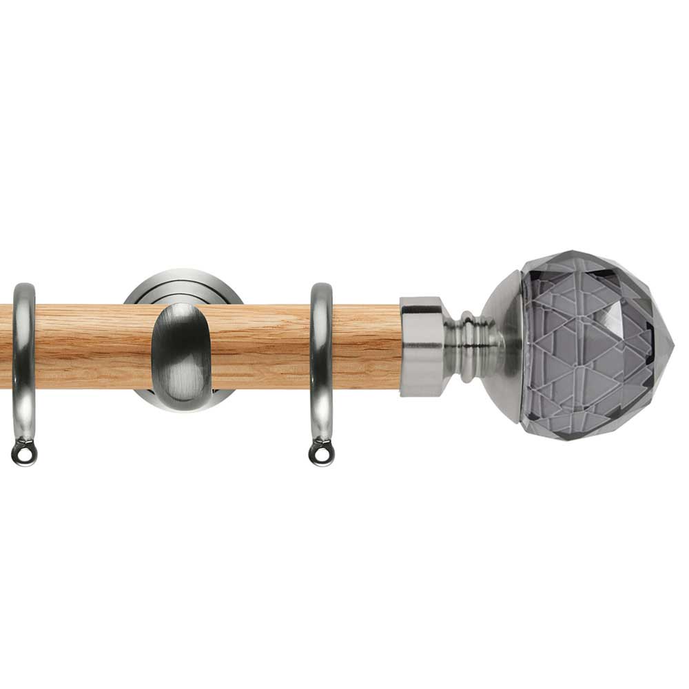 A wooden curtain rod with a crystal ball on top