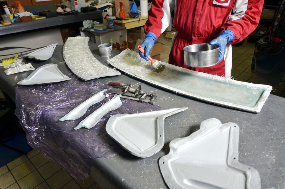 A Person is Painting a Piece of Metal on a Table — Panel Pro Smash Repairs in Wodonga, VIC