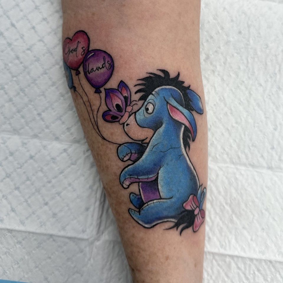 Eeyore tattoo with balloons. Heart-shaped balloon with text 