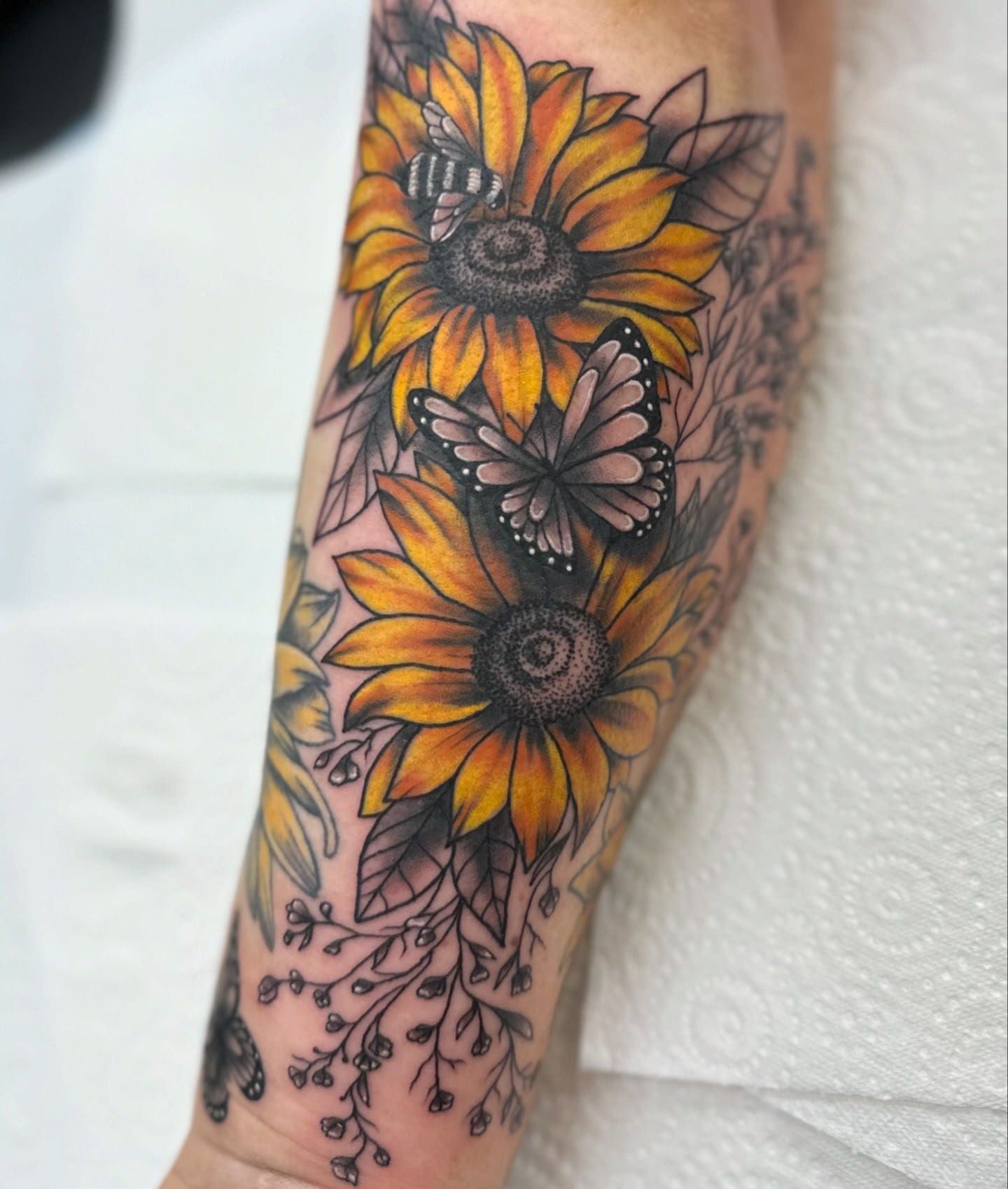 Tattoo of Two Vibrant Yellow Sunflowers With a Butterfly and Bee — Whitsunday Tattooing Airlie Beach in Airlie Beach, QLD