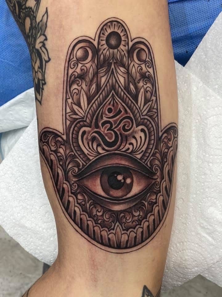 Tattoo of a Hamsa Hand With an Eye and Om Symbol in Grayscale — Whitsunday Tattooing Airlie Beach in Airlie Beach, QLD