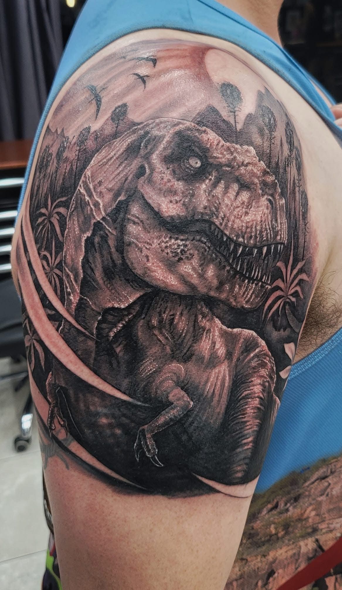 T-Rex Tattoo on Shoulder, Black and Gray Realistic Art — Whitsunday Tattooing Airlie Beach in Airlie Beach, QLD