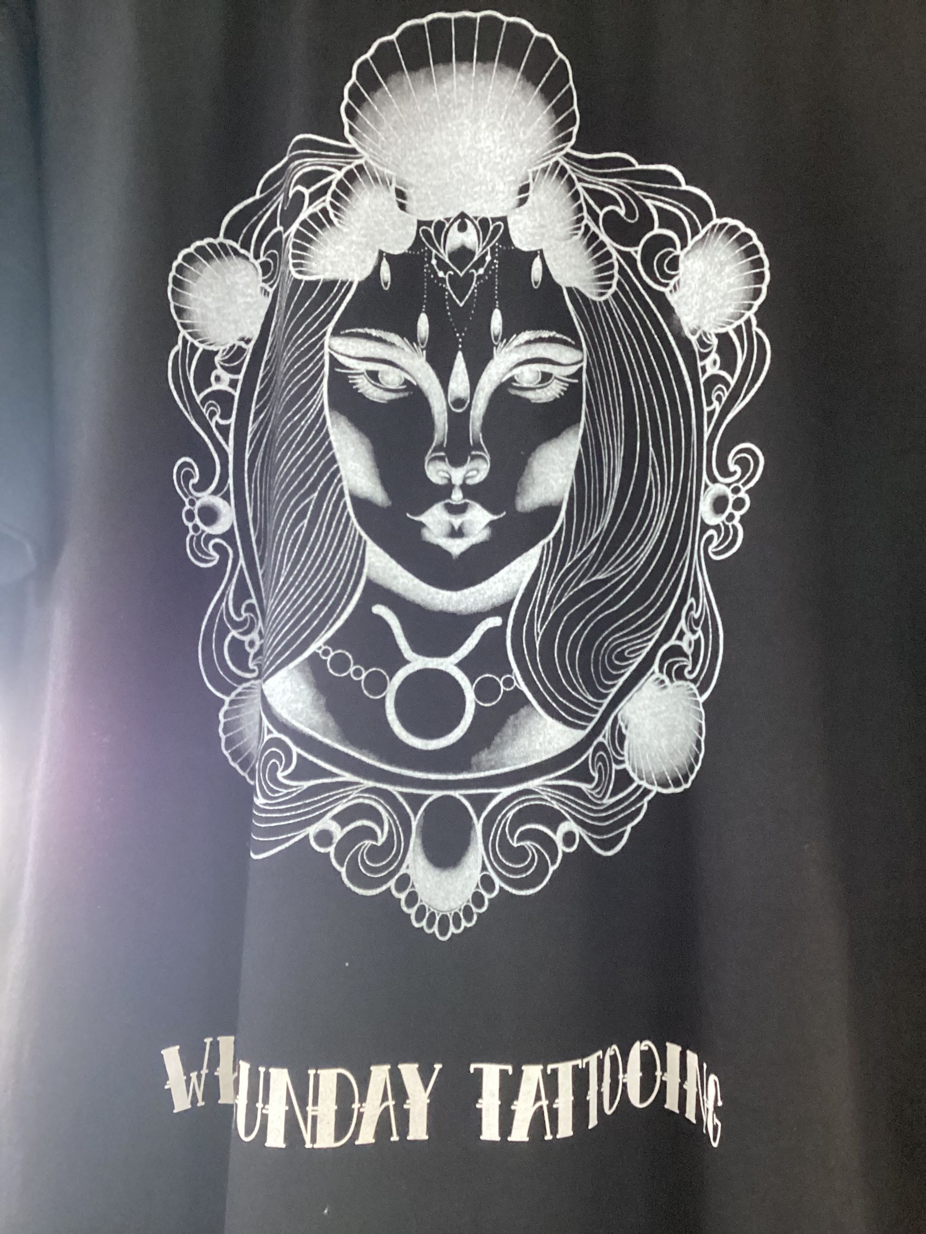 Black T-Shirt with A Silver Illustration of A Woman's Face — Whitsunday Tattooing Airlie Beach in Airlie Beach, QLD