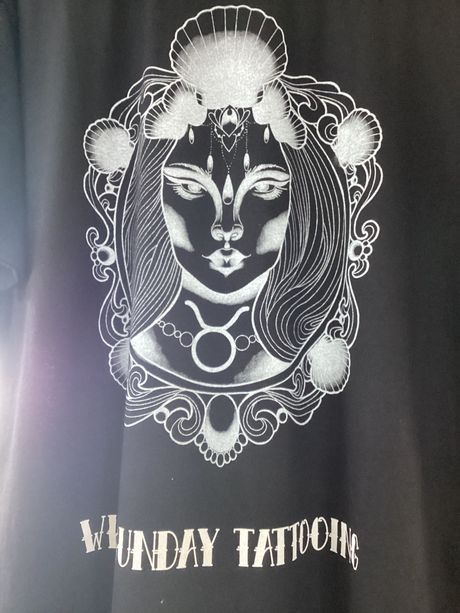 A Silver Illustration of A Woman's Face Within a Seashell — Whitsunday Tattooing Airlie Beach in Airlie Beach, QLD