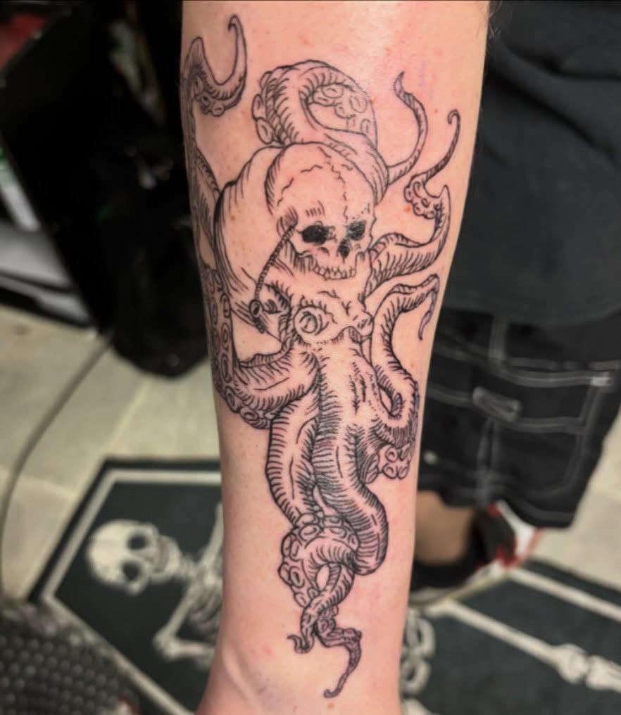 Black tattoo of a skull with horns and tentacle-like details on a person's calf — Whitsunday Tattooing Airlie Beach in Whitsundays, QLD