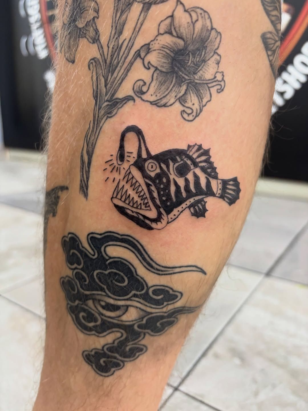 Forearm tattoos: floral linework above a black bird and cloud design — Whitsunday Tattooing Airlie Beach in Whitsundays, QLD