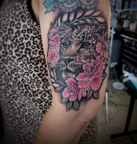 Wolf Tattoo With Pink Flowers on a Person's Upper ARM — Whitsunday Tattooing Airlie Beach in Airlie Beach, QLD