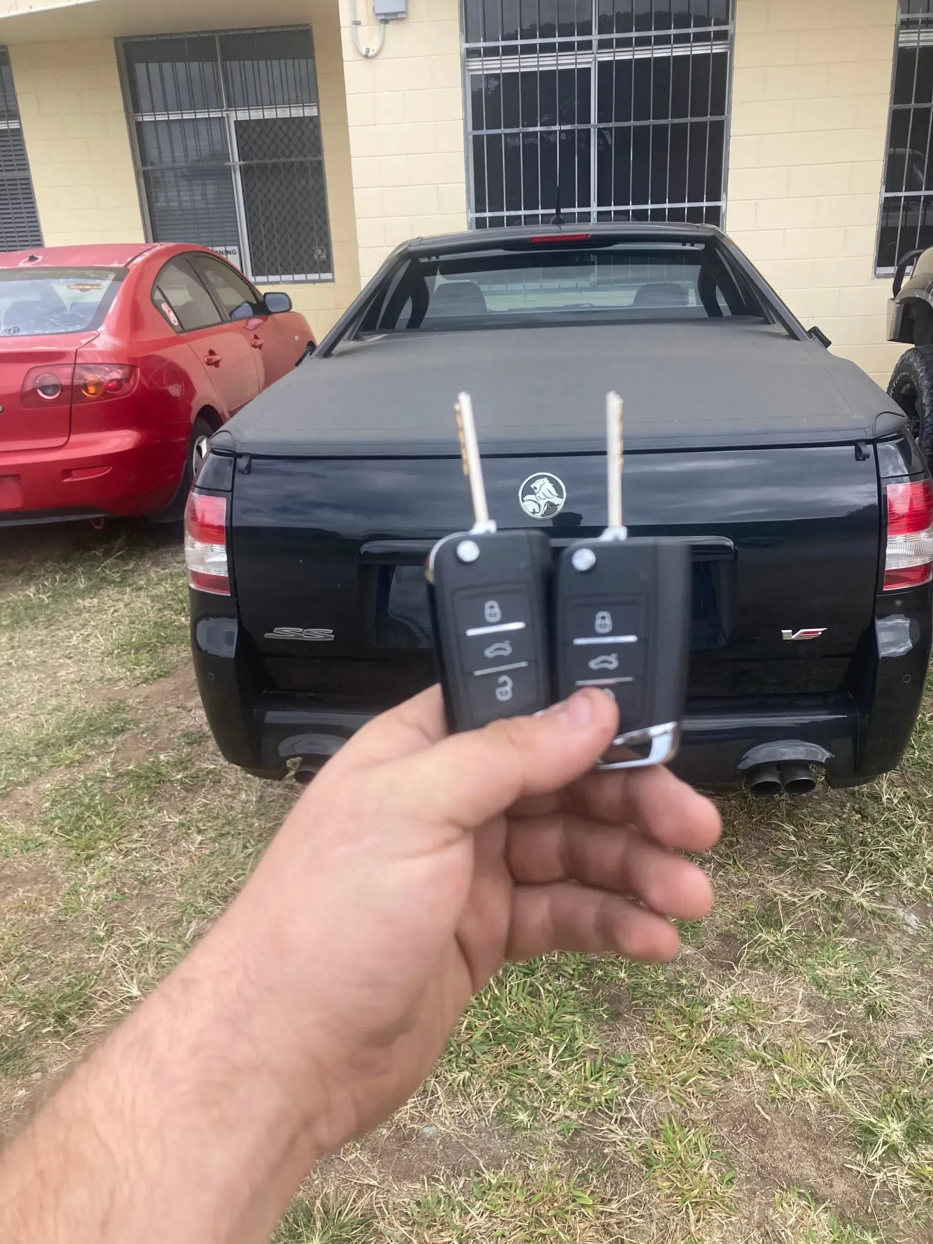 Person Using Lock Picks to Open a Red Car Door — Nq Locksmiths in Ingham, QLD