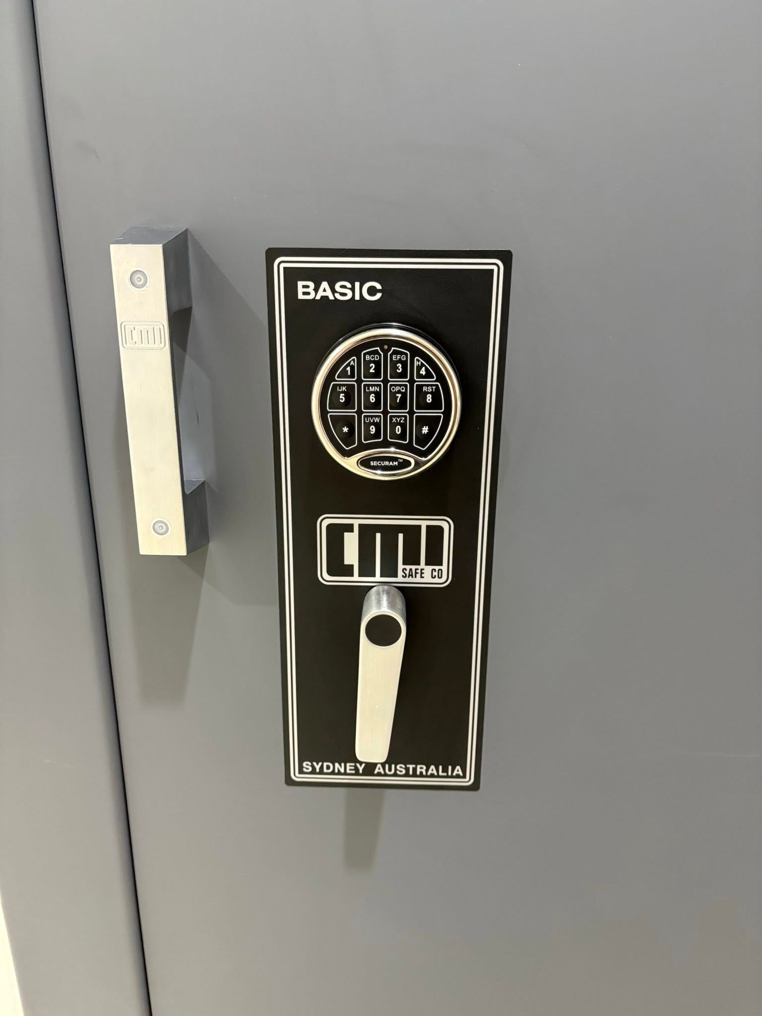 A Gray Door Edge with A Wood-Toned Door Handle Hole, in A Garage — Nq Locksmiths in Ingham, QLD