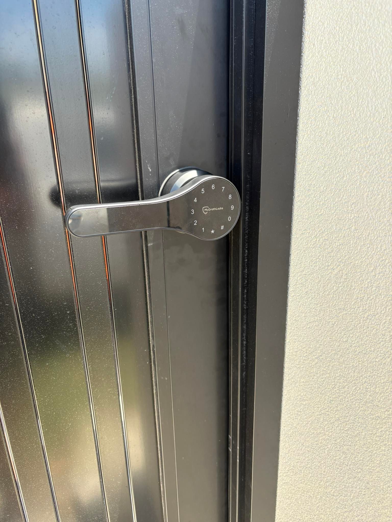 Black Metal Door with A Silver Handle and A Digital Keypad — Nq Locksmiths In Kirwan, QLD