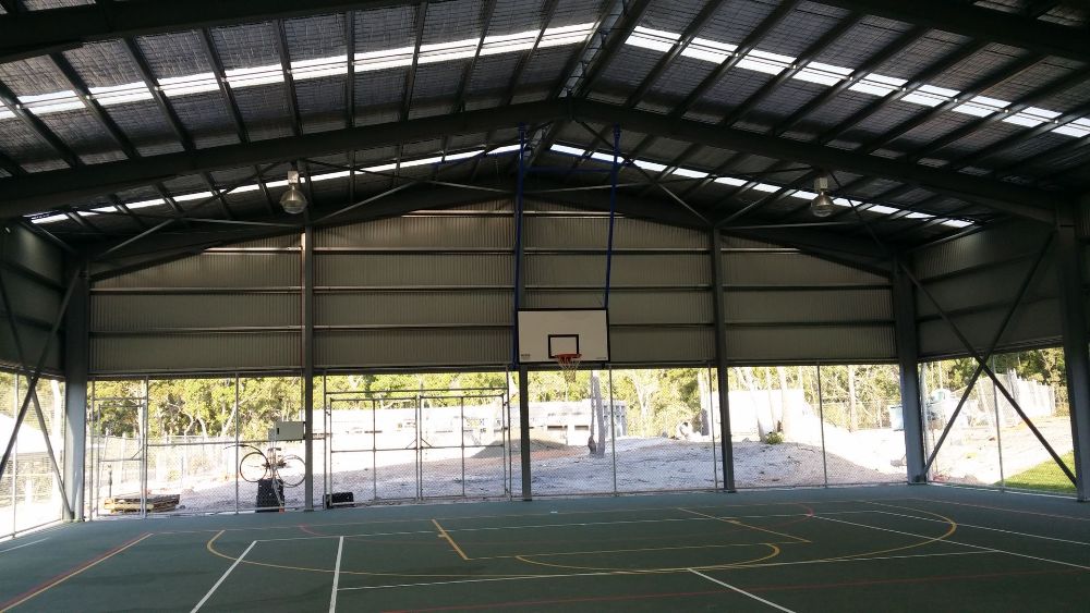 A Large White Building With a Sign on the Side That Says 'Aqua' — Mareeba Sheds & Gas In Mareeba, QLD
