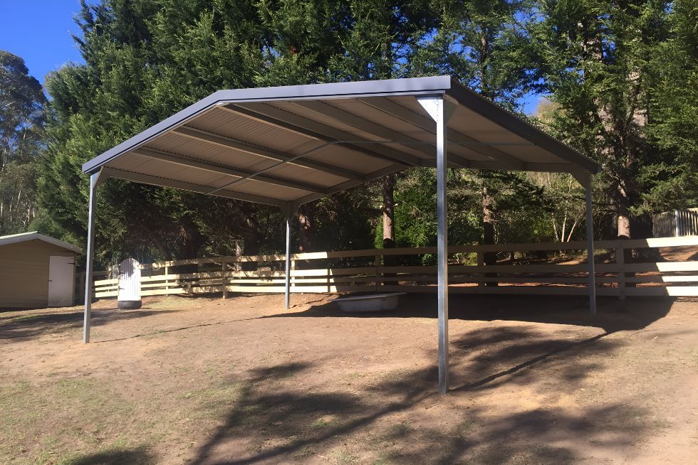 A Covered Area With a Fence and Trees in the Background — Mareeba Sheds & Gas In Mareeba, QLD
