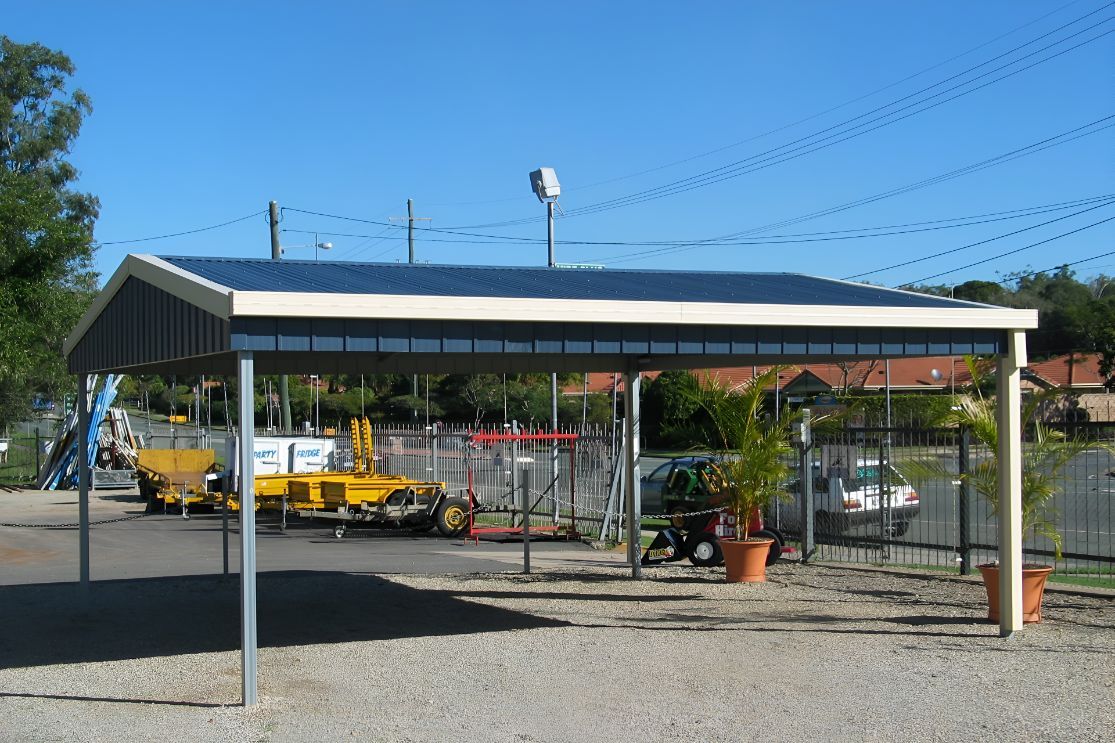 A Carport With a Blue Roof in a Gravel Area — Mareeba Sheds & Gas In Mareeba, QLD