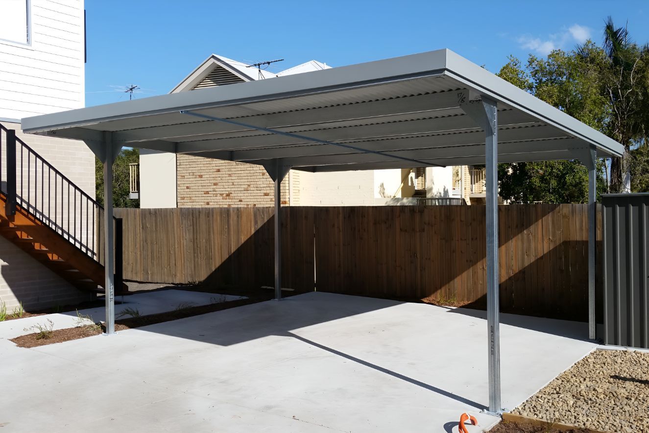 A Carport With a Wooden Fence and Stairs in the Background — Mareeba Sheds & Gas In Cairns, QLD