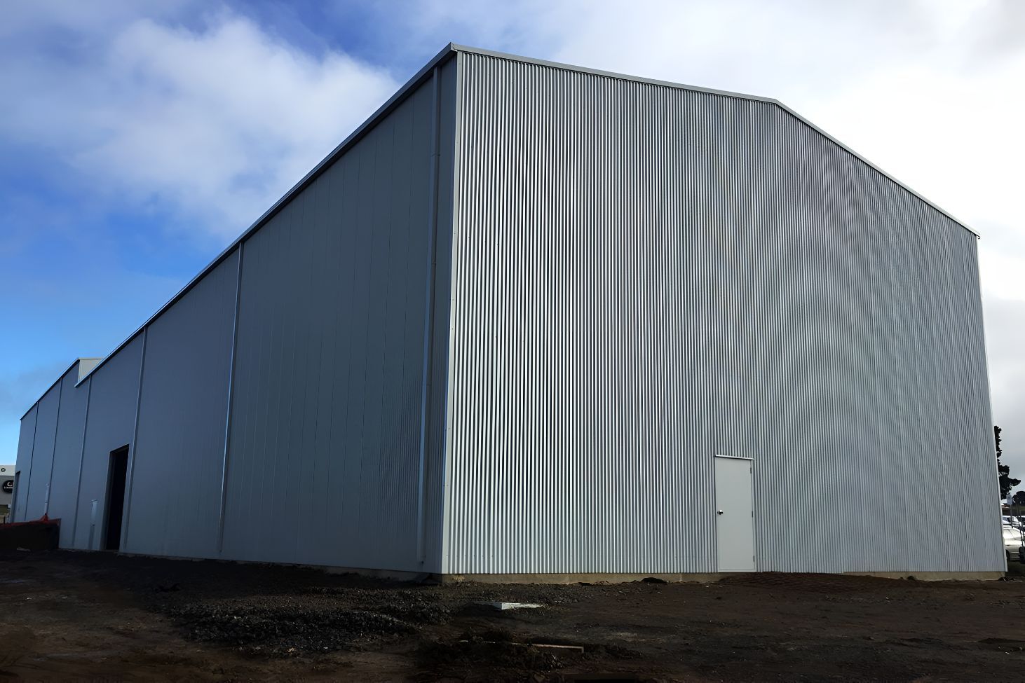 A Large White Building With a Blue Sky in the Background — Mareeba Sheds & Gas In Cairns, QLD