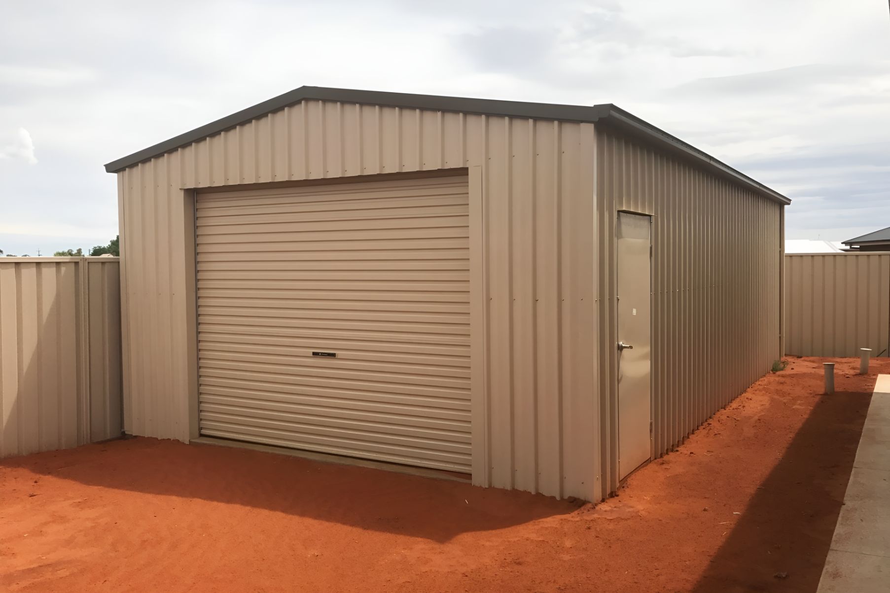 A Garage With a Garage Door and a Door in a Backyard — Mareeba Sheds & Gas In Port Douglas, QLD