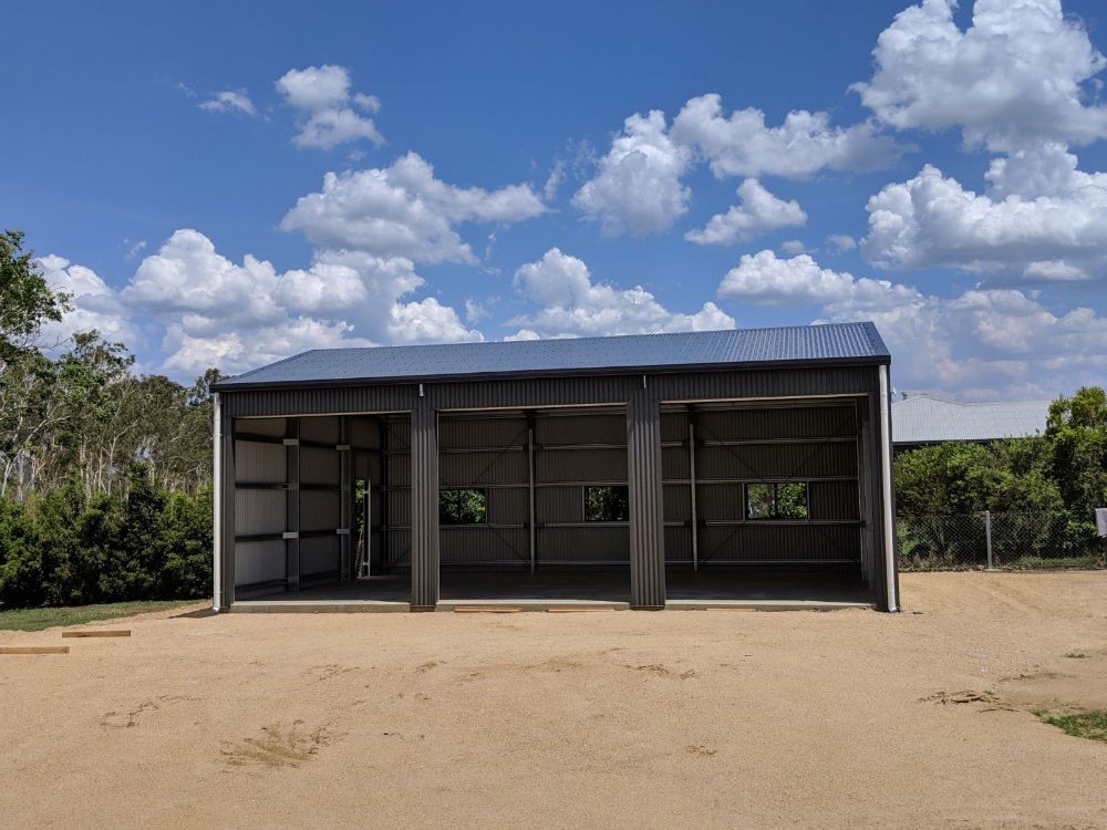 Two Cars Are Parked Under a Canopy in a Driveway — Mareeba Sheds & Gas In Mareeba, QLD