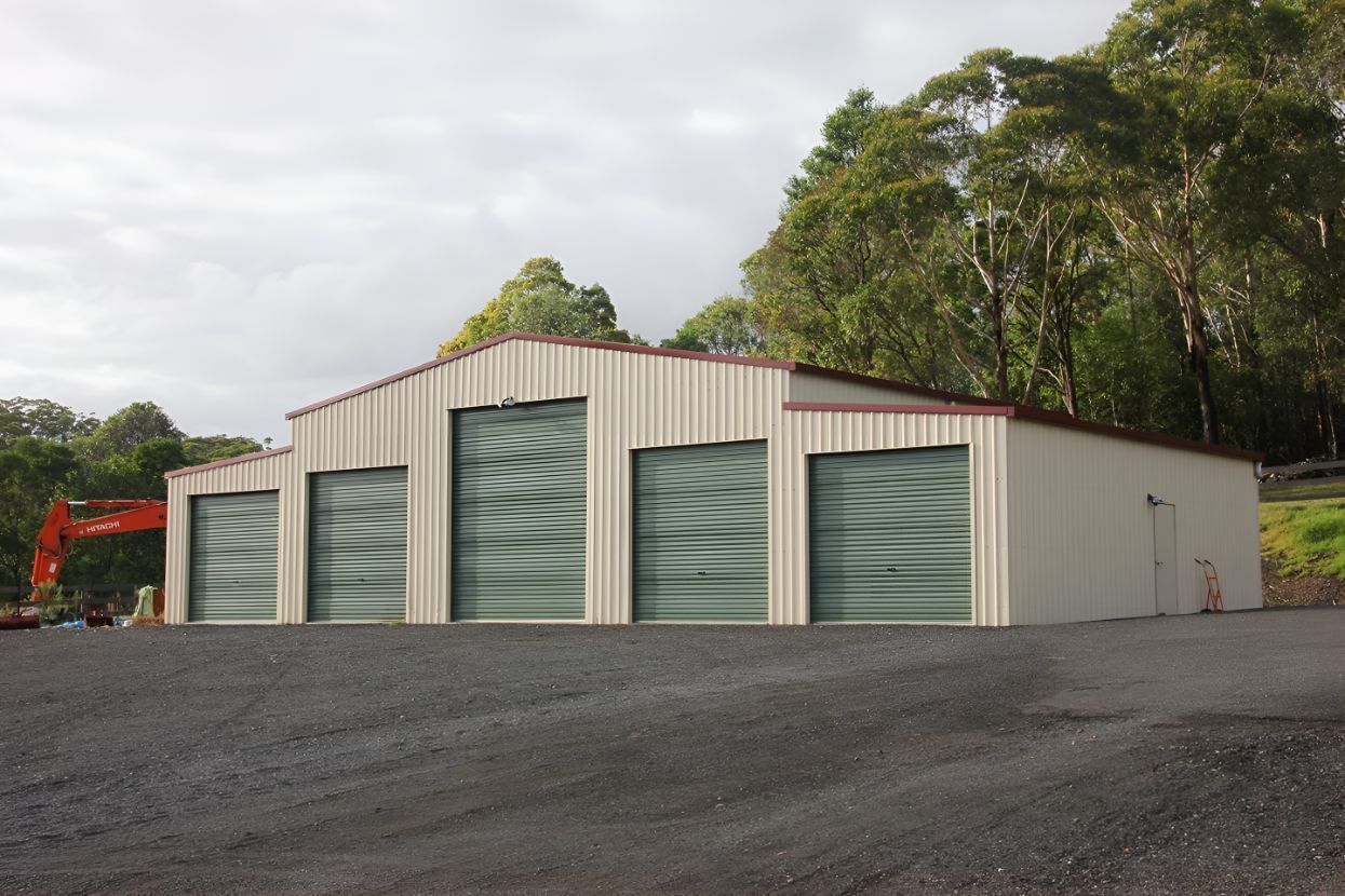 A Building With a Lot of Doors and Trees in the Background — Mareeba Sheds & Gas In Tablelands, QLD