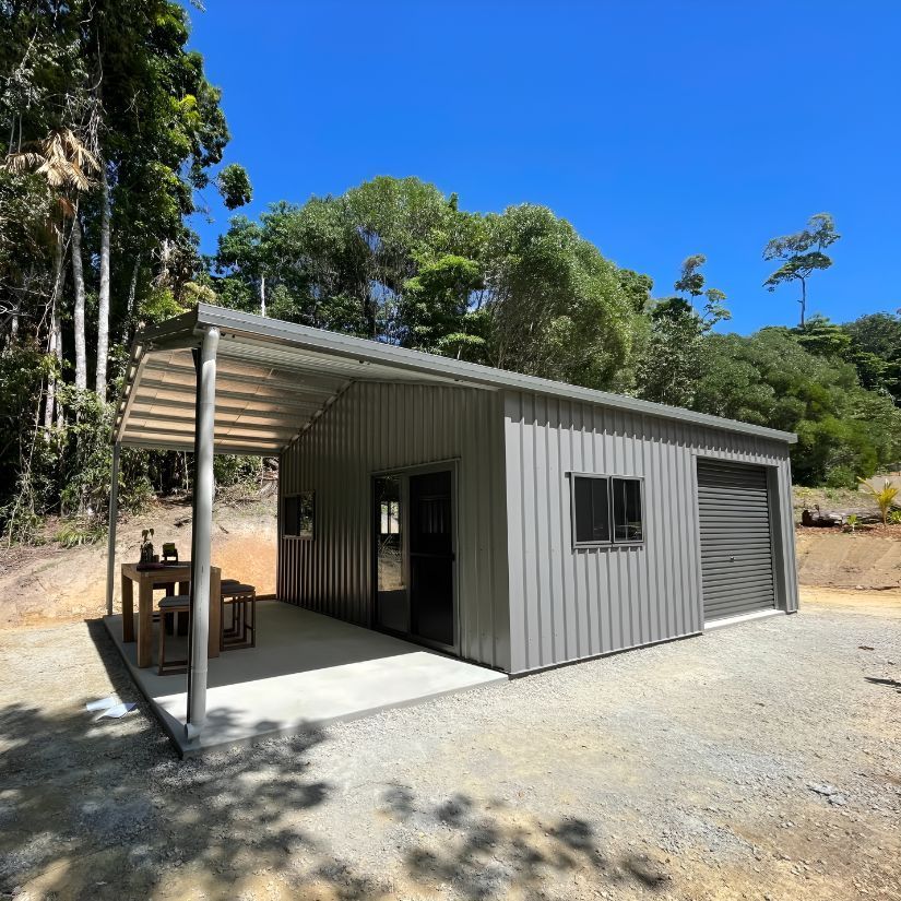 A Small House With a Covered Porch and Trees in the Background — Mareeba Sheds & Gas In Mareeba, QLD