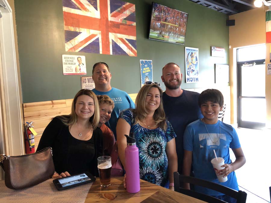 A group of people are posing for a picture in a restaurant.