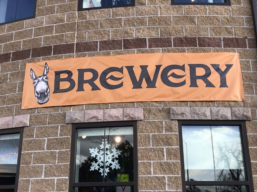 A brick building with a sign that says brewery on it