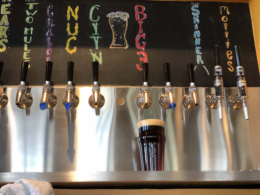 A row of beer taps with one that says nuts on it