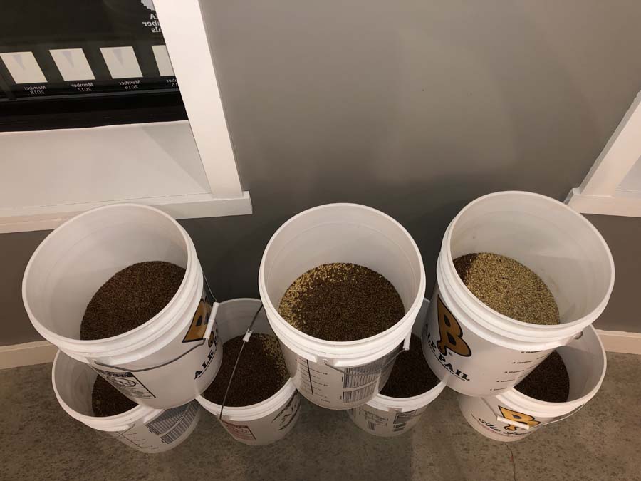 A row of buckets filled with different types of food