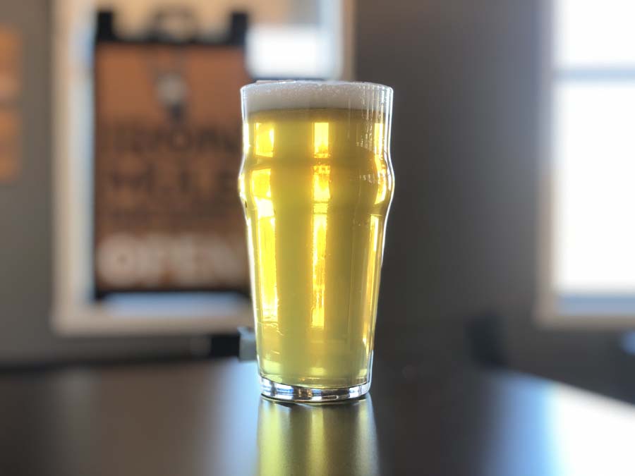 A glass of beer is sitting on a table