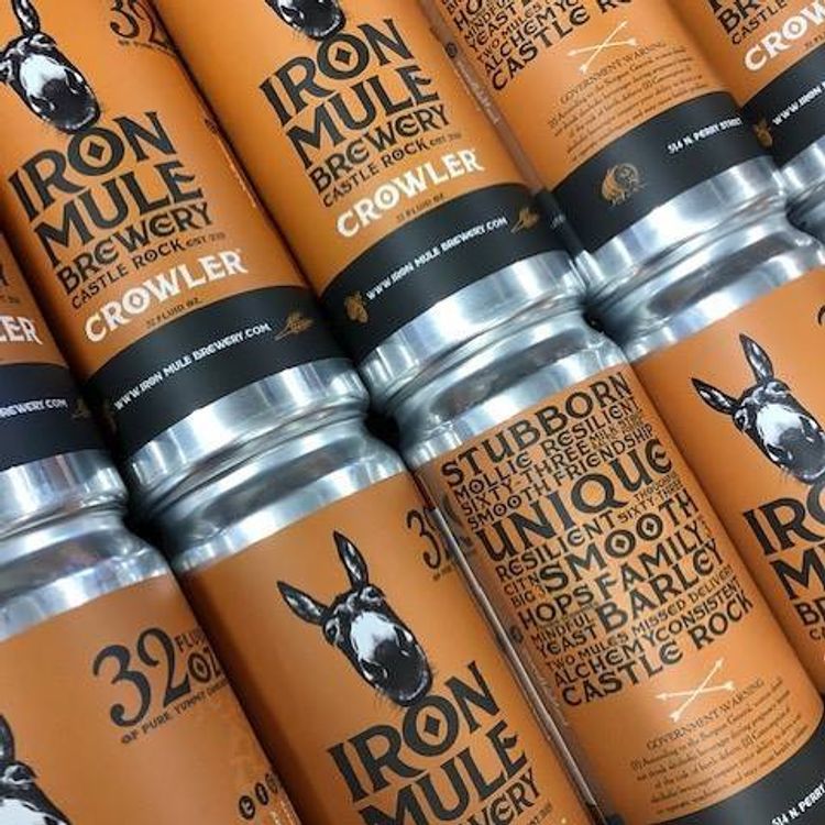 Several cans of iron mule brewery crowler are stacked on top of each other