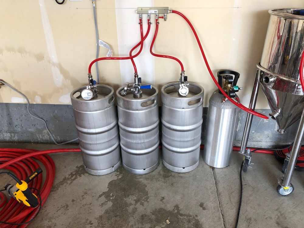 A bunch of kegs are stacked on top of each other