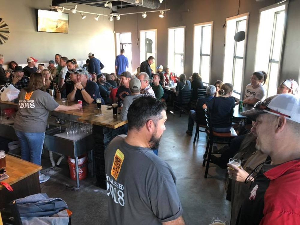 A group of people are sitting at tables in a restaurant.