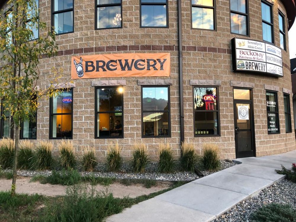 A brick building with a sign that says brewery on it.