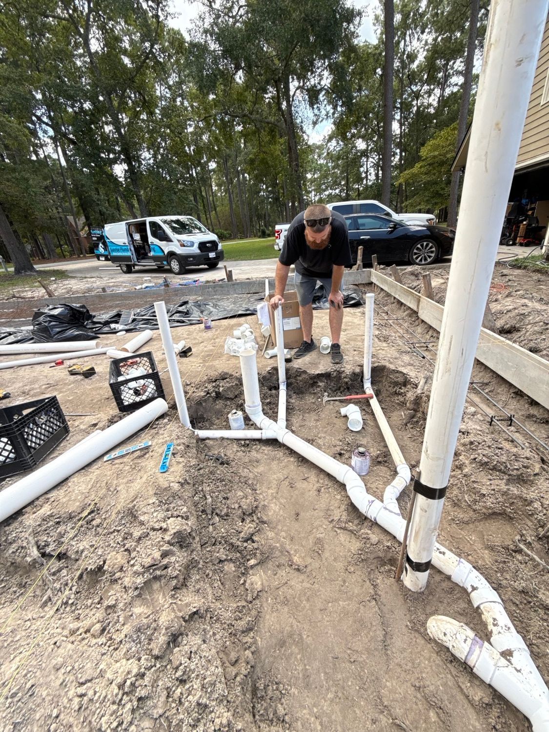 Exposed floor joists with plumbing and wiring in a construction renovation area