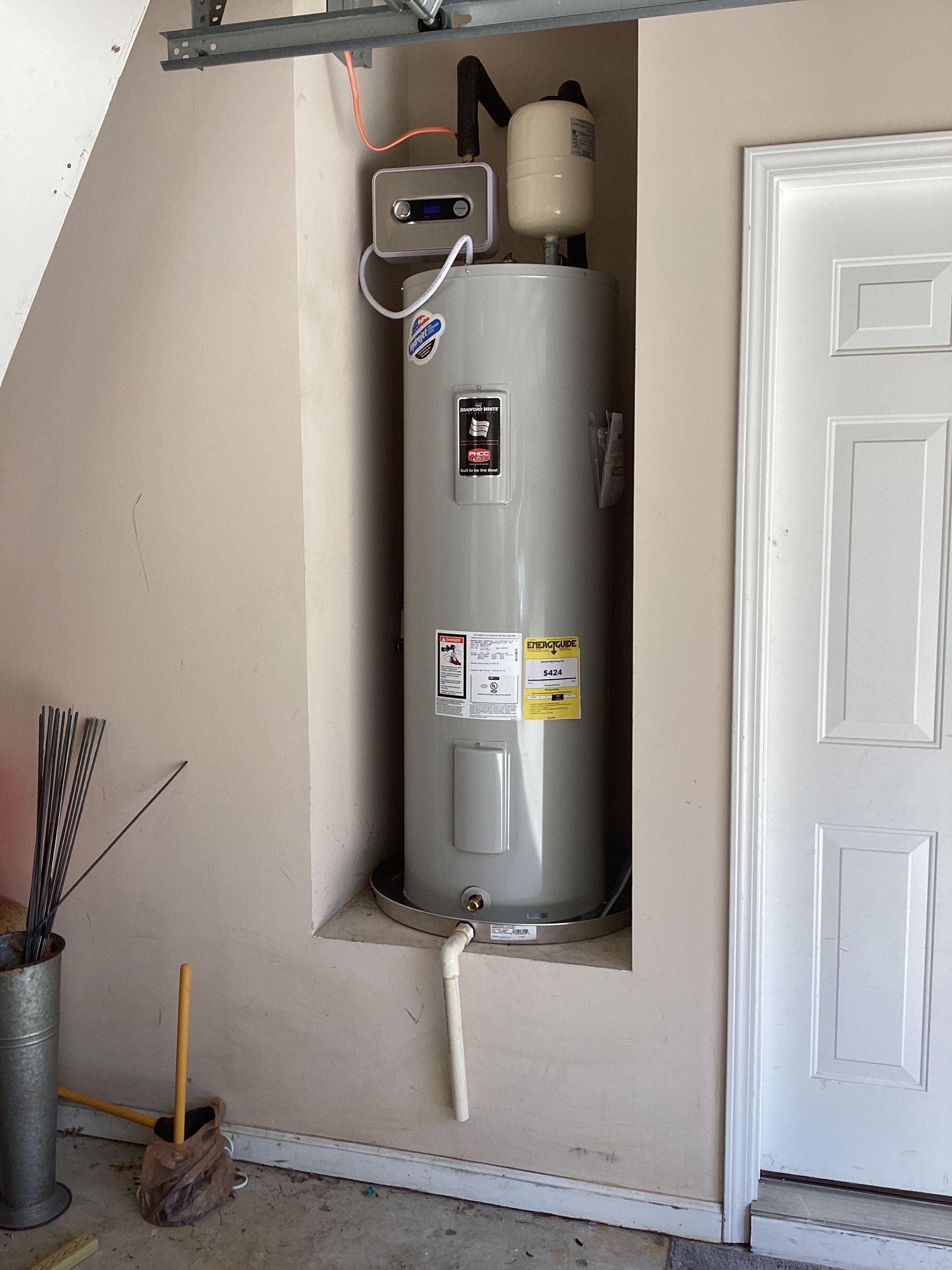 Water Heater Repair, Installation & Replacement - Hands repairing a sink fixture with a wrench under a white basin - Savannah, GA
