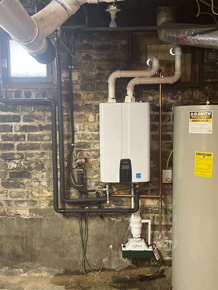 Water Heater Installation & Repair -mounted boiler with pipes beside a water heater in a basement utility room - Savannah, GA