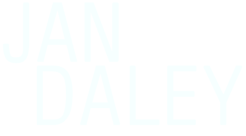 The logo for jan daley is blue and has a geometric design.