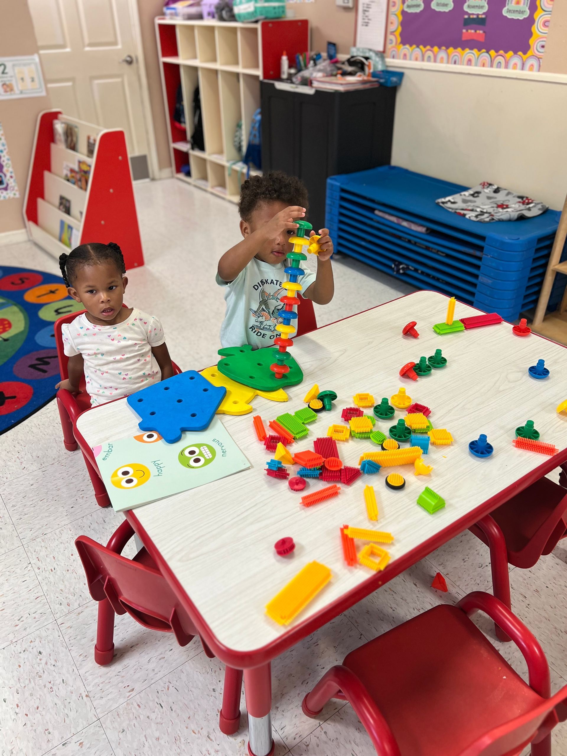 A group of children are sitting in a yellow toy car.