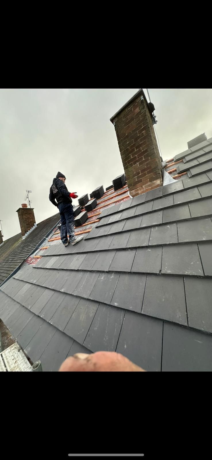 A picture of Hightop Roofers in Huddersfield installing roof slates