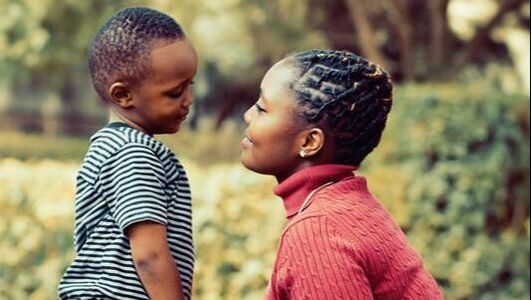 A woman and a child are looking at each other.