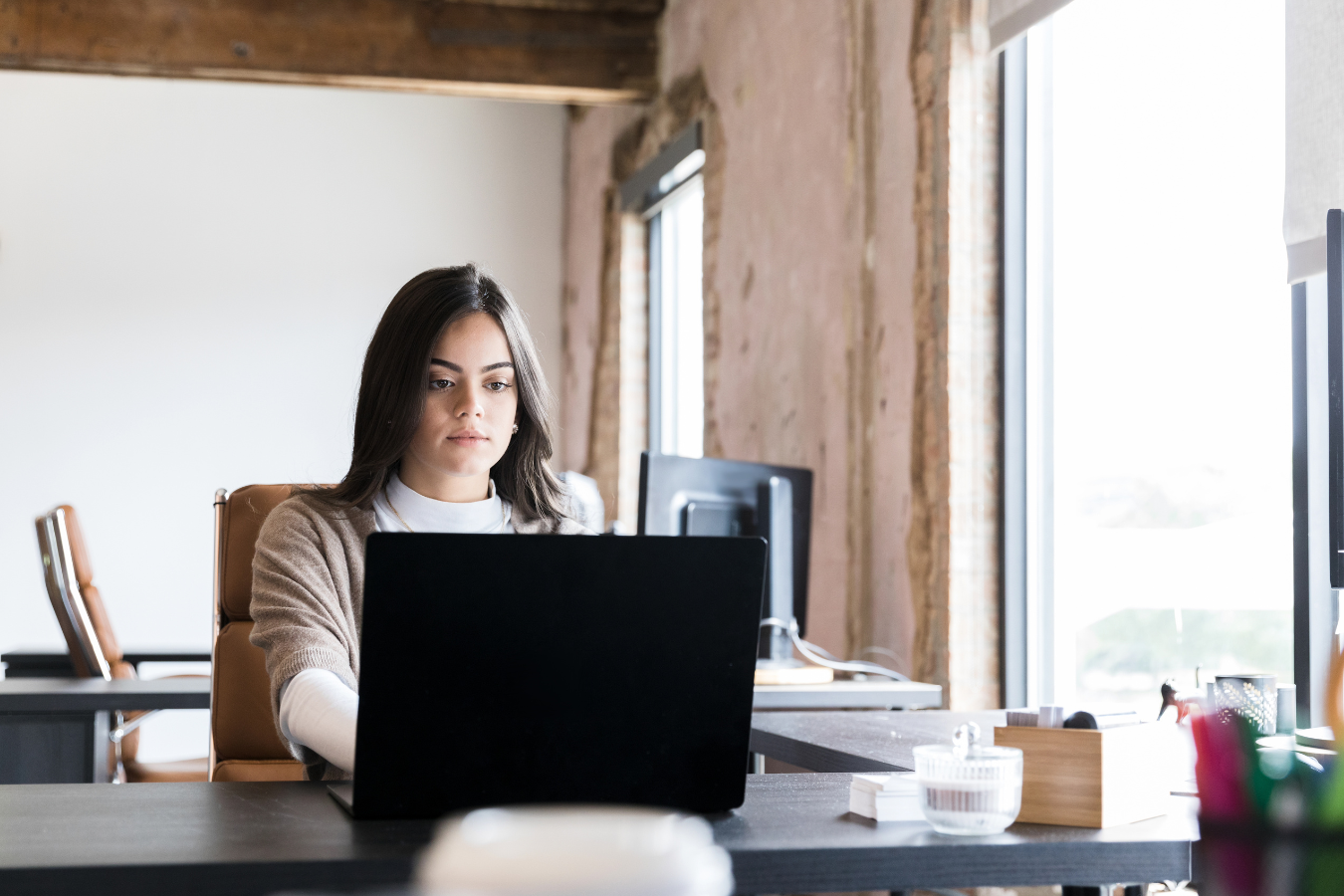 A professional woman works at her computer 