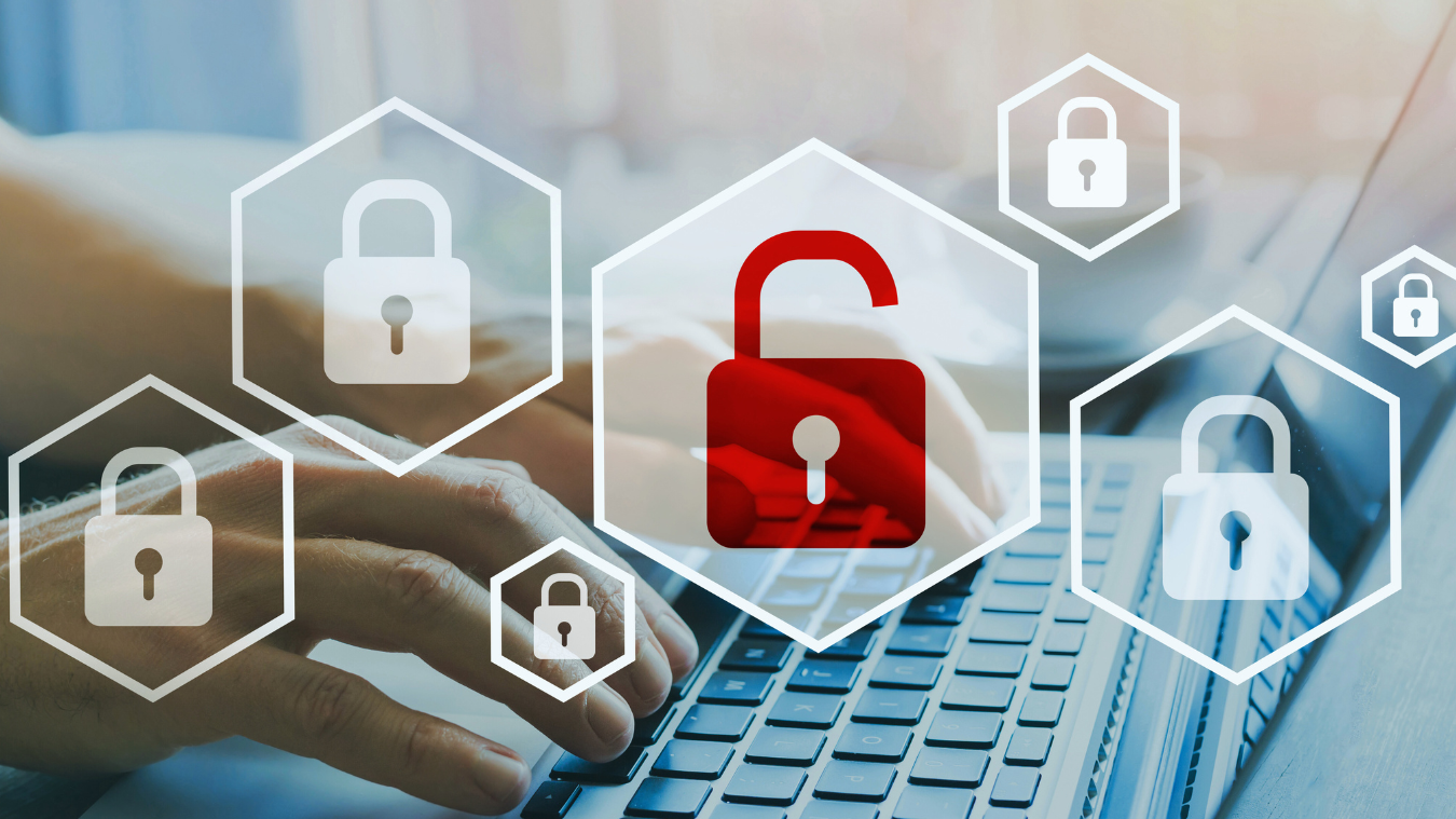 a person is typing on a laptop computer with a red padlock in the middle