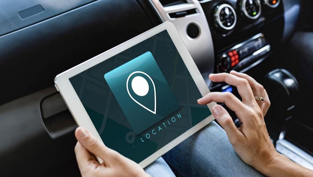 A person is using a tablet in a car.