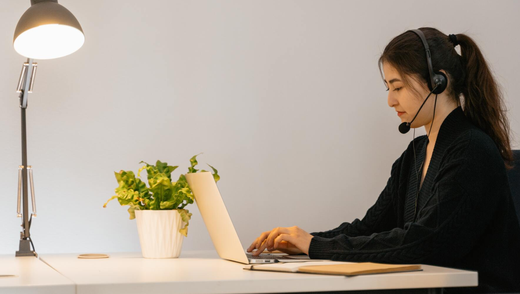woman works on a laptop as a virtual assistant for a small business