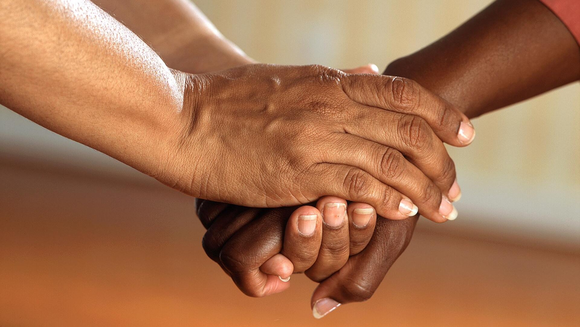 two hands holding each other