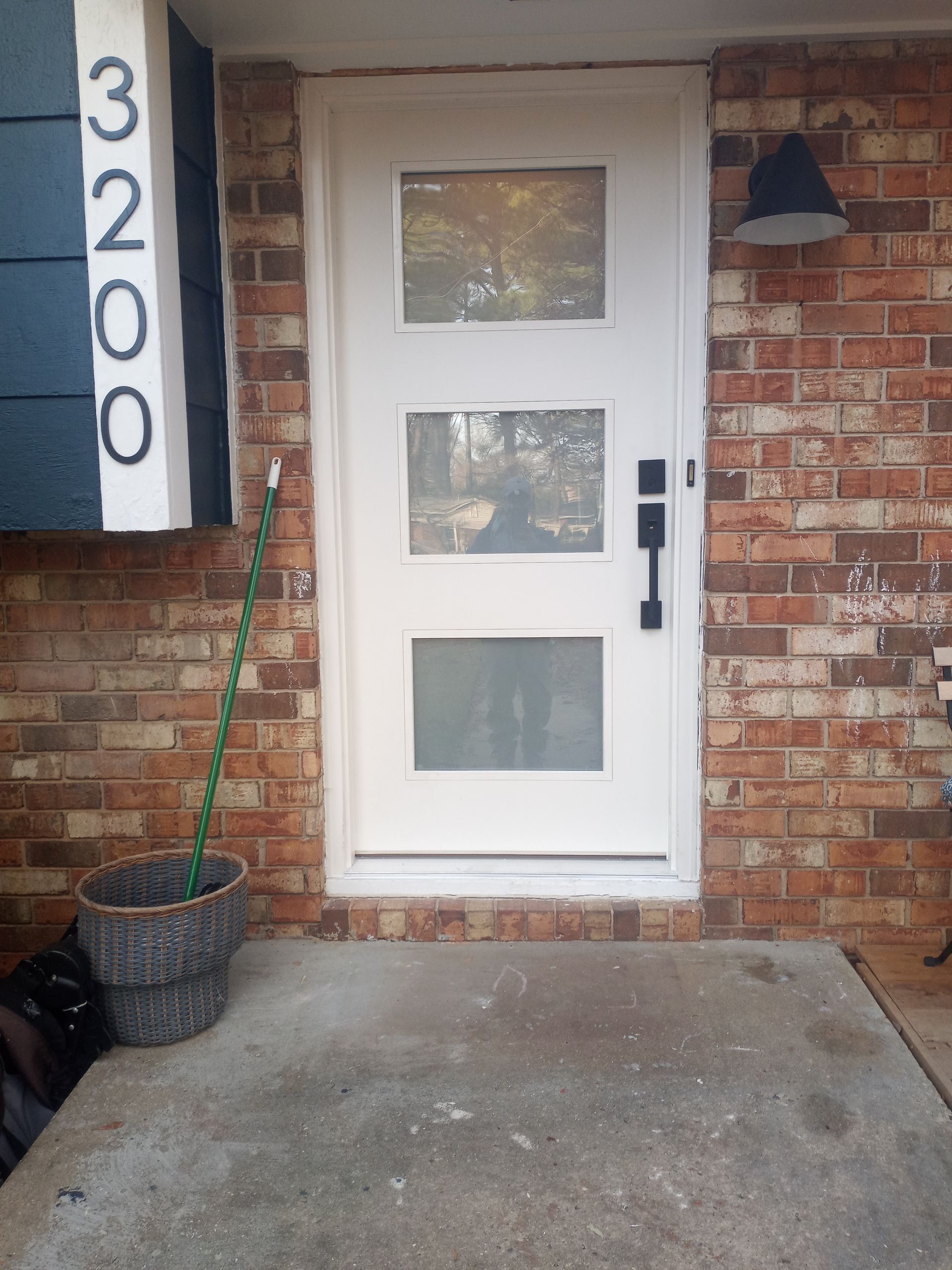 The front door of a brick house with a white door