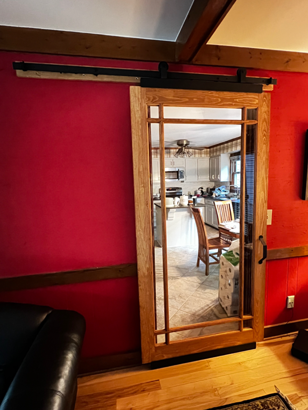 A living room with a sliding glass door leading to a kitchen.
