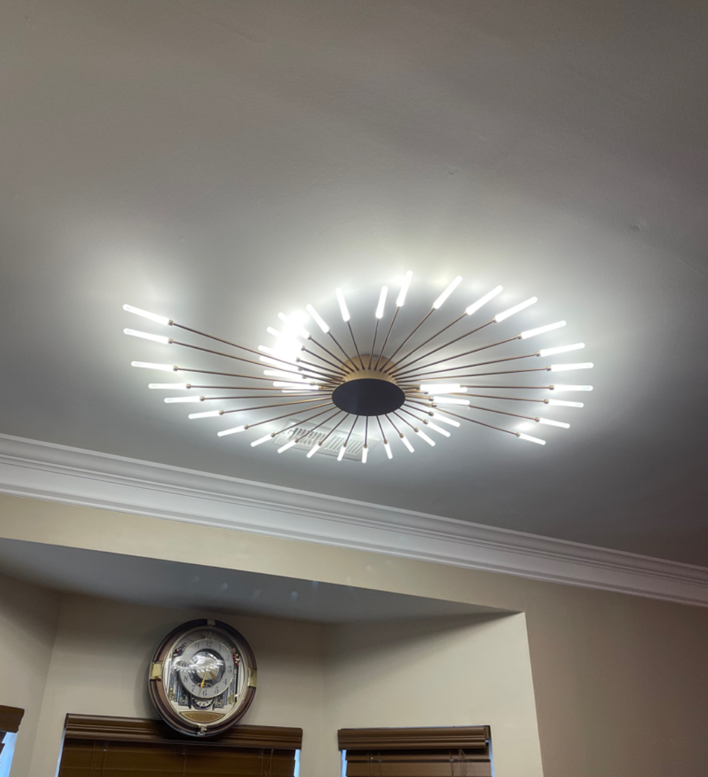 A room with a clock on the wall and a light on the ceiling